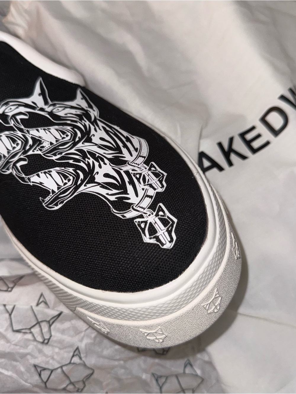 Naked Wolfe Black Canvas Slip-On with White Wolf Graphic